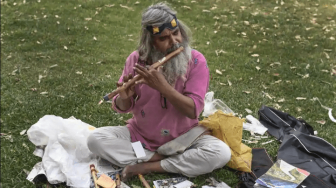 Guitar Rao playing flute
